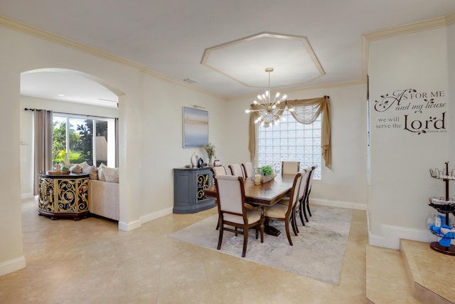 dining space with crown molding and a chandelier