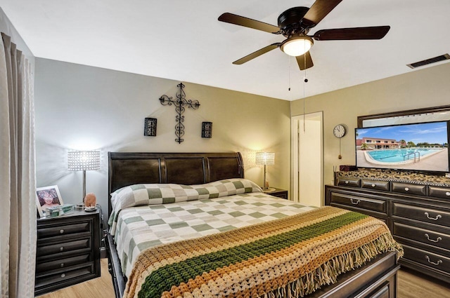 bedroom with ceiling fan and light hardwood / wood-style flooring