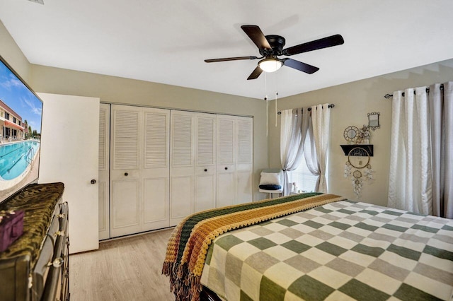 bedroom with ceiling fan, a closet, and light wood-type flooring