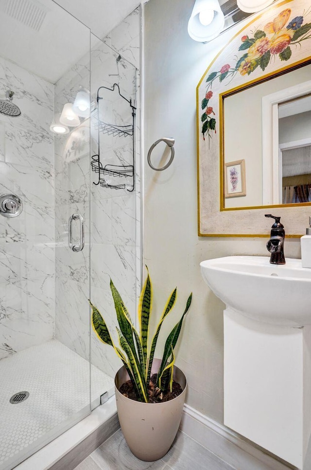 bathroom featuring a shower with door