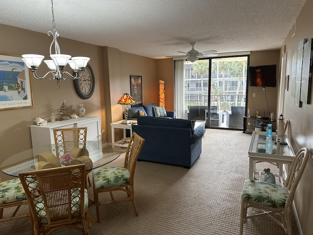 dining area featuring expansive windows, ceiling fan with notable chandelier, a textured ceiling, and carpet flooring