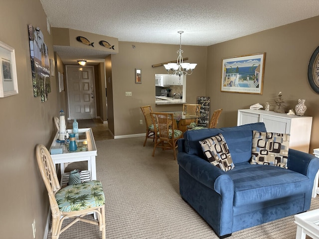 living room with a textured ceiling, a chandelier, and light carpet