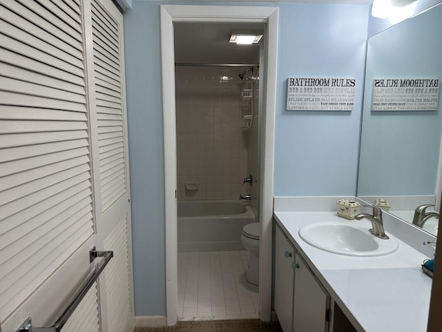 full bathroom featuring toilet, tiled shower / bath, tile patterned floors, and vanity