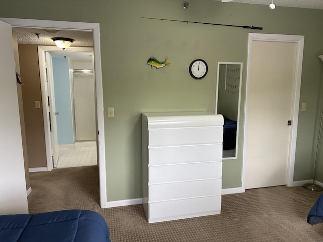 bedroom with a textured ceiling and carpet