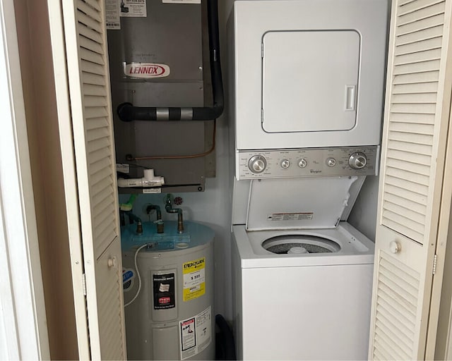 laundry area featuring water heater and stacked washer and dryer