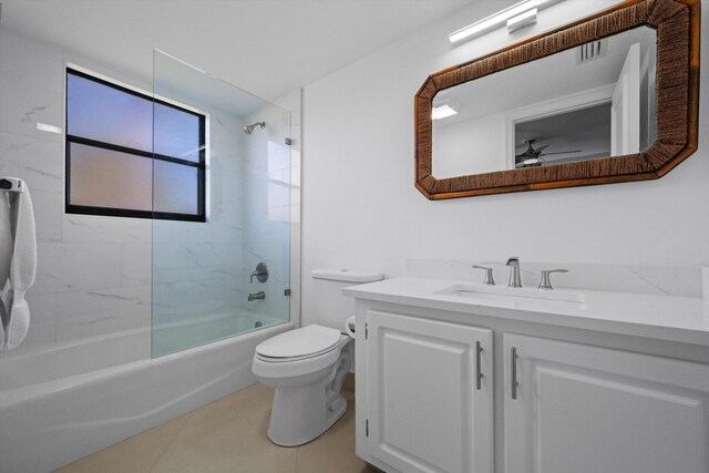 full bathroom featuring toilet, tile patterned floors, vanity, and tiled shower / bath