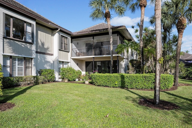 rear view of house with a yard