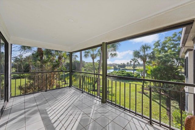 unfurnished sunroom featuring a water view