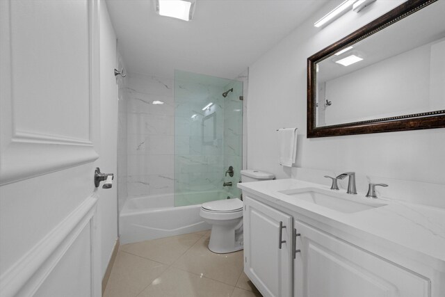 full bathroom with vanity, tile patterned flooring, toilet, and tiled shower / bath