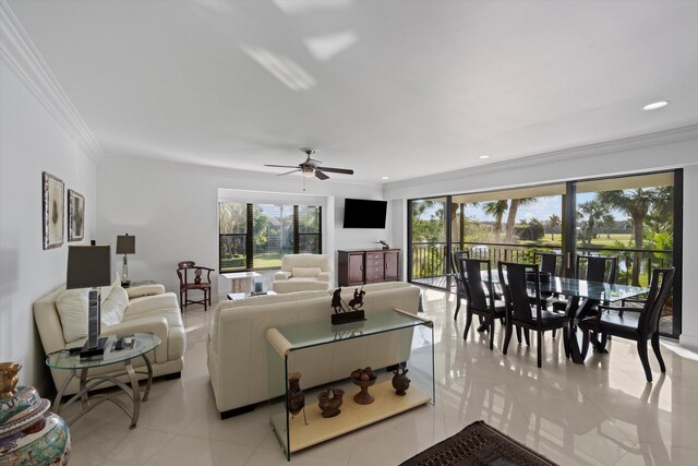 dining space with ceiling fan, a wealth of natural light, and crown molding