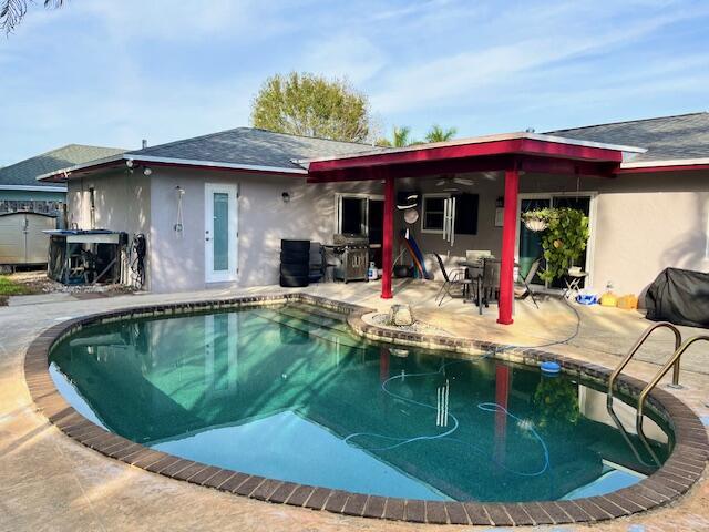 pool with a patio area and grilling area