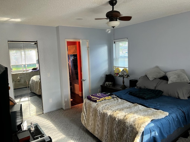 bedroom with access to exterior, a textured ceiling, carpet floors, baseboards, and ceiling fan