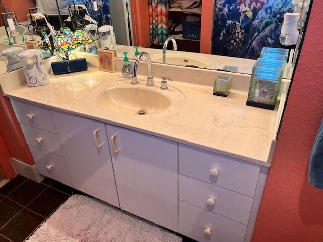 bathroom featuring tile patterned flooring and vanity