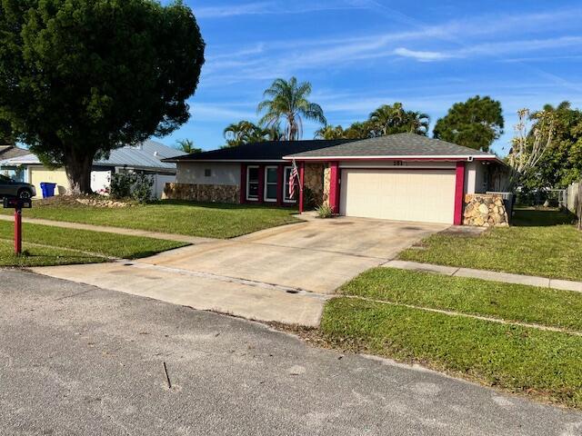 single story home with a garage and a front lawn