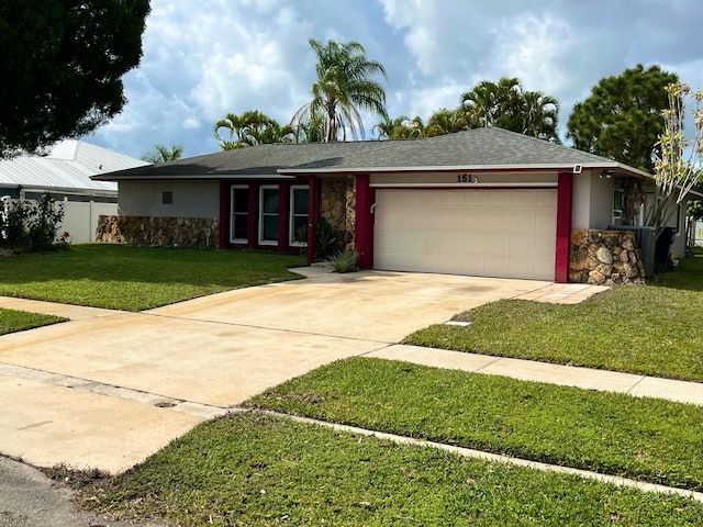 single story home with stucco siding, stone siding, a front yard, and an attached garage