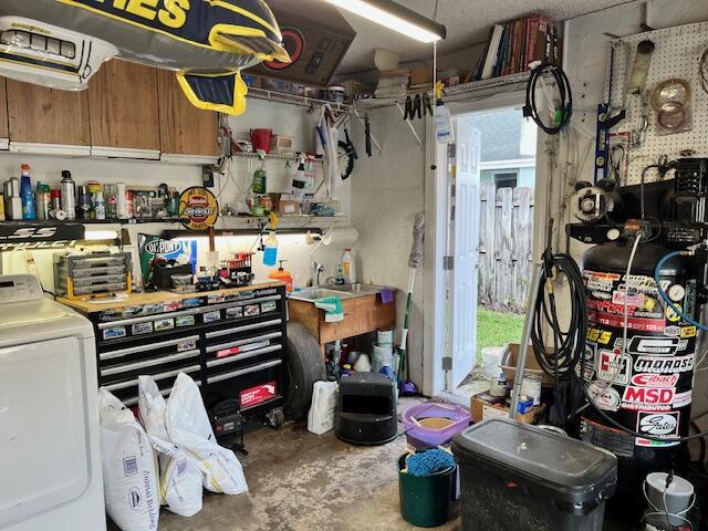 garage featuring washer / clothes dryer and a workshop area