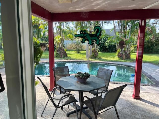 view of swimming pool with a fenced in pool, a patio, and fence