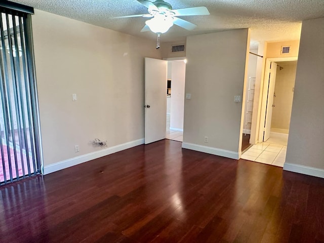 spare room featuring hardwood / wood-style flooring, a textured ceiling, and ceiling fan