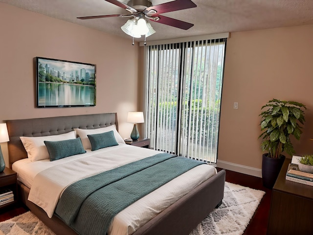 bedroom featuring a textured ceiling, ceiling fan, and hardwood / wood-style flooring