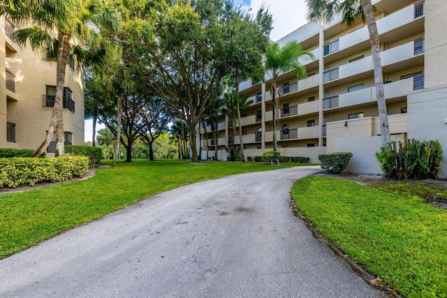 surrounding community featuring a lawn and visible vents