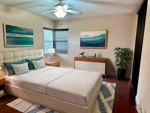 bedroom with ceiling fan and dark hardwood / wood-style flooring