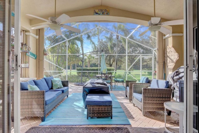 view of patio / terrace with a lanai, an outdoor living space, and ceiling fan