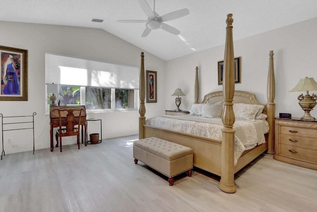 bedroom featuring a textured ceiling, ceiling fan, lofted ceiling, and light hardwood / wood-style flooring