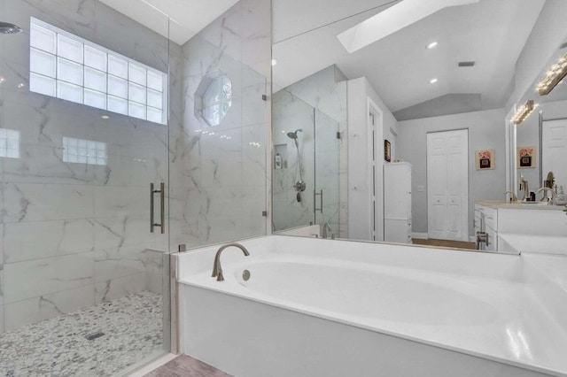 bathroom featuring shower with separate bathtub, lofted ceiling with skylight, and vanity