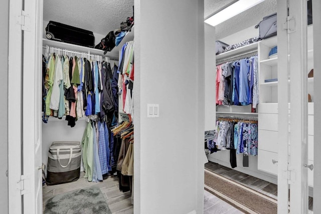 walk in closet with light wood-type flooring