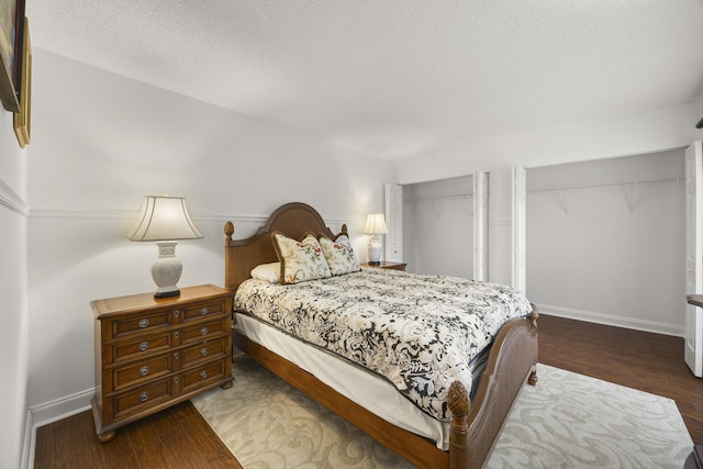 bedroom featuring dark hardwood / wood-style floors and a textured ceiling