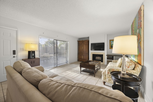 living room with a textured ceiling and light tile patterned floors