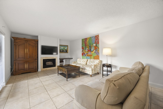 living room with light tile patterned flooring and a textured ceiling