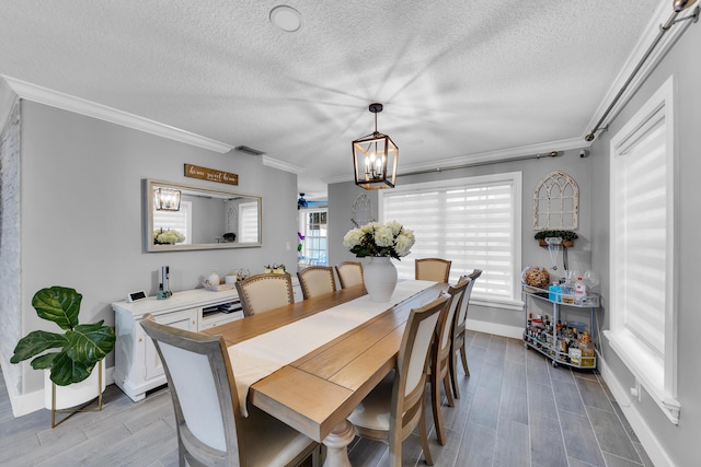 dining room with a chandelier, crown molding, and wood-type flooring