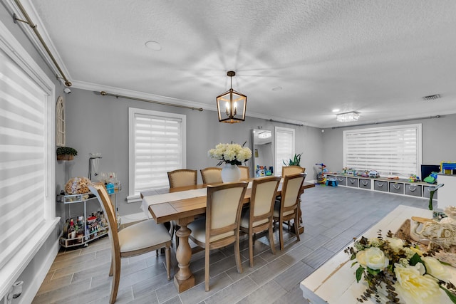 dining space featuring crown molding and a textured ceiling