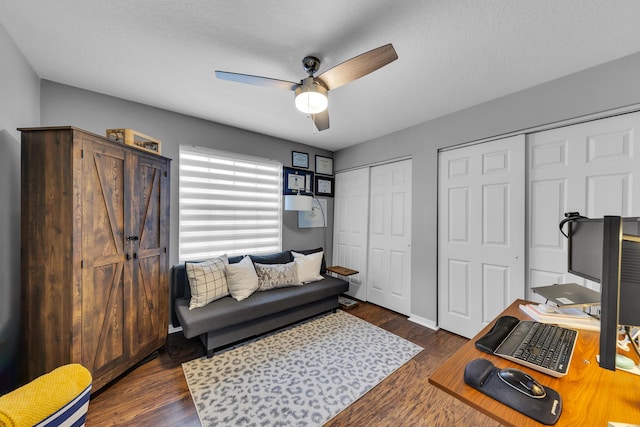 office area featuring a textured ceiling, ceiling fan, and dark hardwood / wood-style flooring