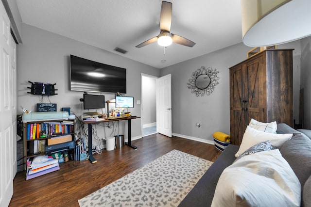 bedroom with ceiling fan and dark hardwood / wood-style floors