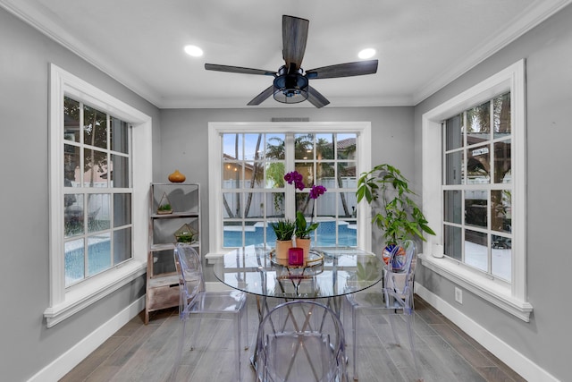 dining room with ceiling fan, ornamental molding, and a healthy amount of sunlight