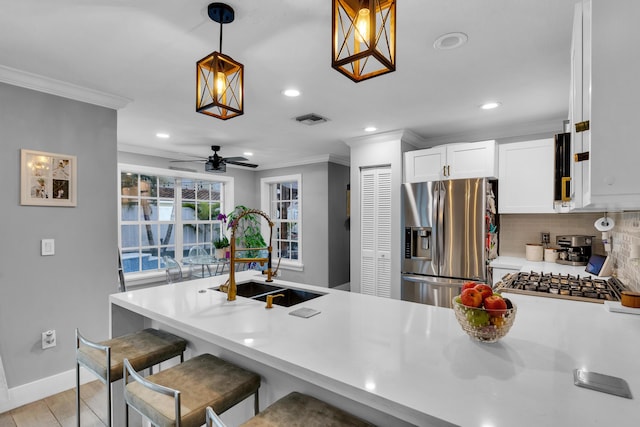 kitchen with stainless steel fridge with ice dispenser, decorative backsplash, kitchen peninsula, pendant lighting, and a breakfast bar