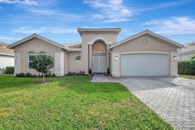 view of front of house with a garage and a front lawn