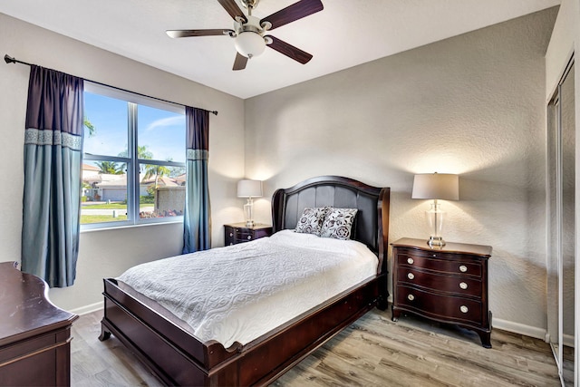 bedroom with ceiling fan and light hardwood / wood-style floors