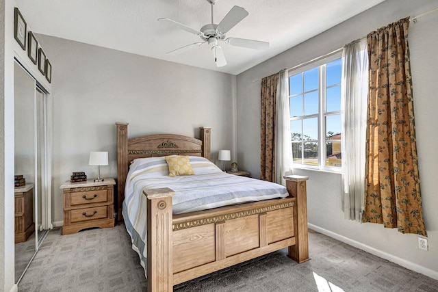 carpeted bedroom with a closet and ceiling fan