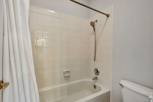 bathroom featuring toilet and shower / tub combo