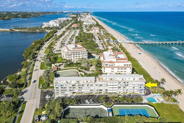 drone / aerial view with a water view and a beach view