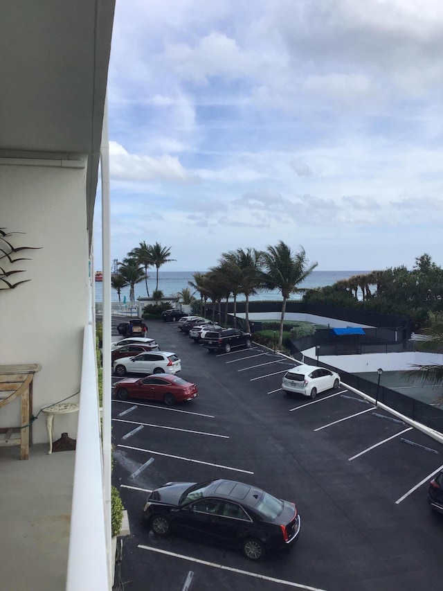 view of vehicle parking featuring a water view