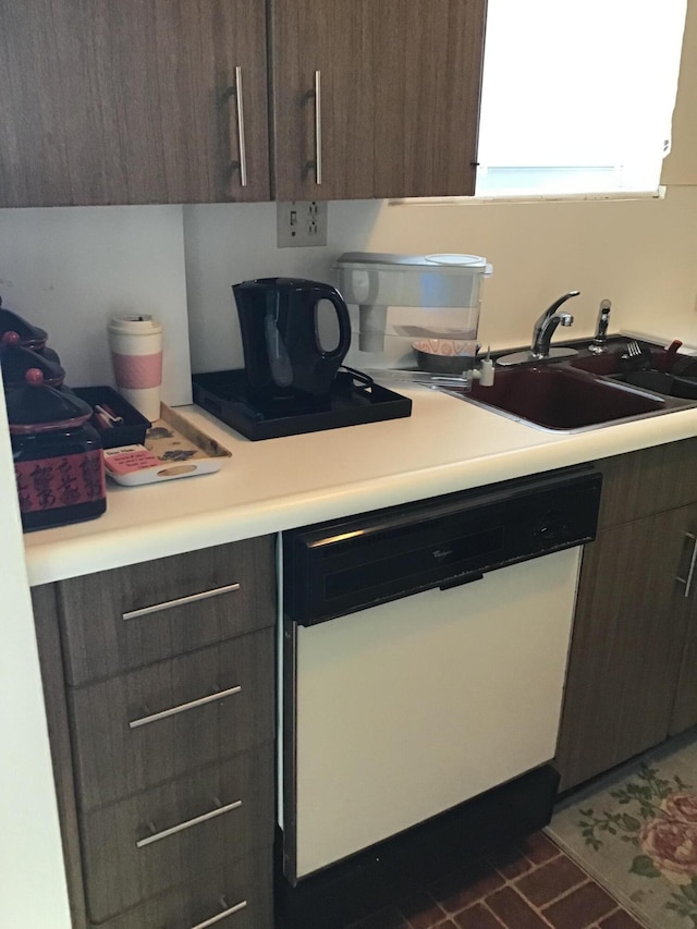 kitchen featuring dark brown cabinets, dark tile patterned floors, white dishwasher, and sink