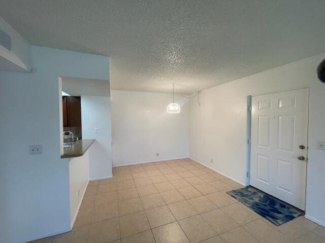 empty room with a textured ceiling and sink