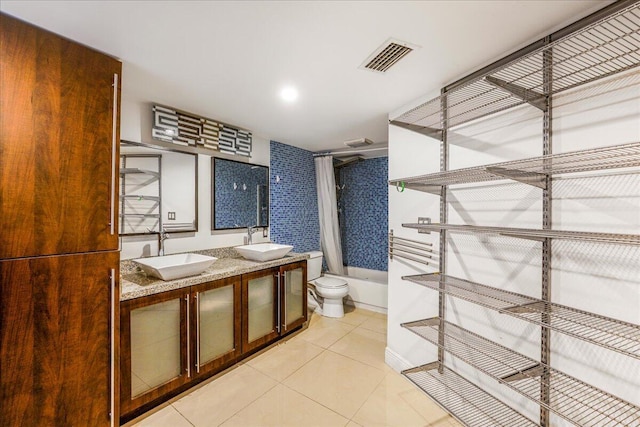 full bathroom with shower / bath combination with curtain, toilet, vanity, and tile patterned flooring