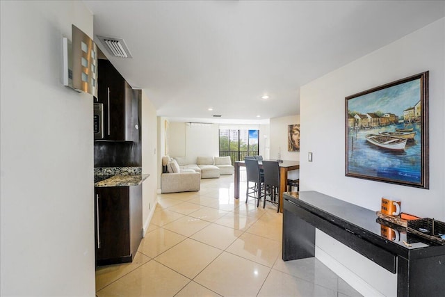 hall featuring light tile patterned flooring