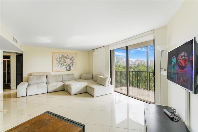 living room featuring floor to ceiling windows and light tile patterned floors