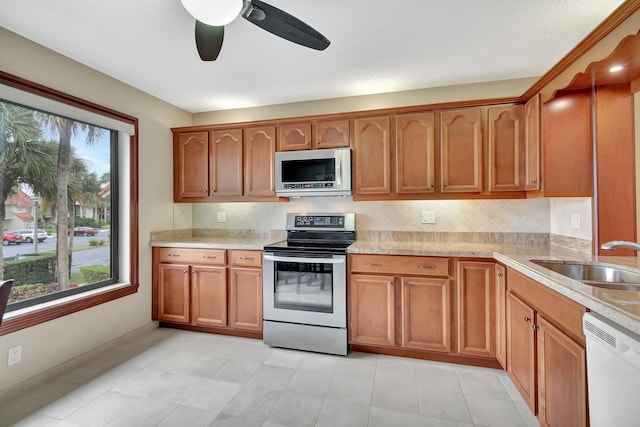 kitchen featuring appliances with stainless steel finishes, sink, a wealth of natural light, and ceiling fan